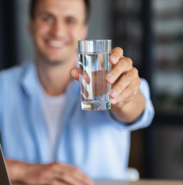 Man Raising a Glass of Water