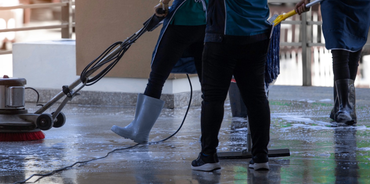 Workers completing full floor care services in a commercial space