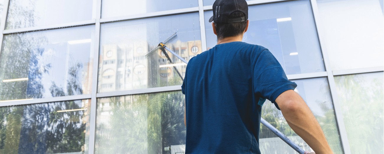 Man Performing Commercial Window Cleaning Services