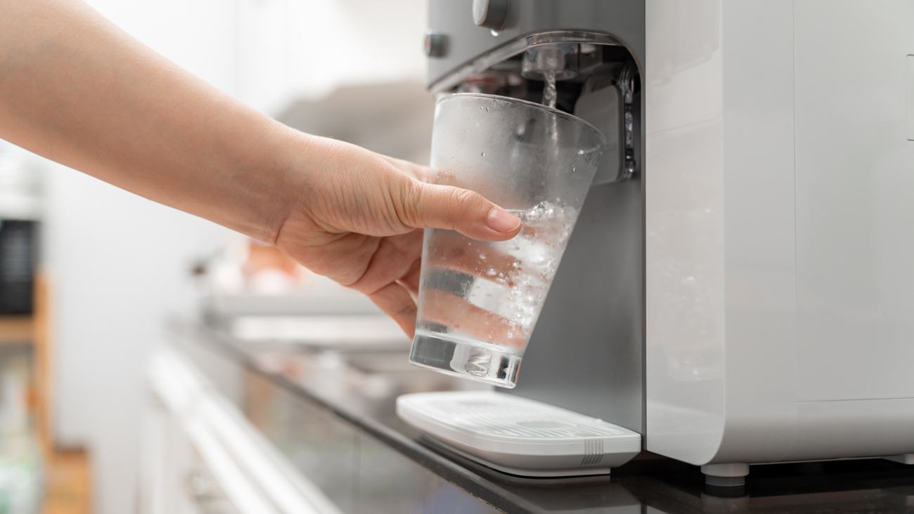 Woman filling water using bottleless water system