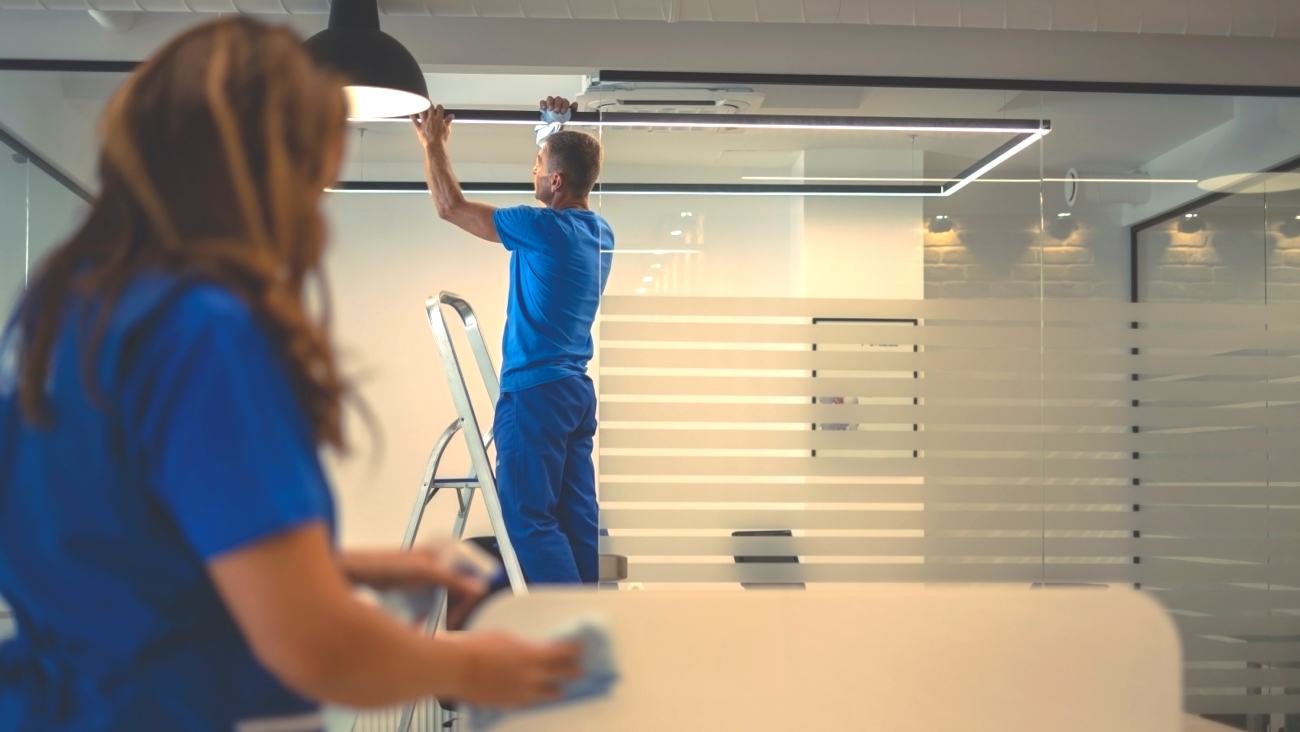 Two professional cleaners cleaning in office Two professional cleaners cleaning in office