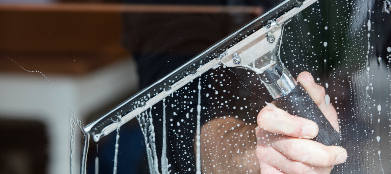 Professional window cleaning with squeegee Professional window cleaning with squeegee