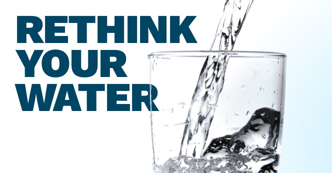 Water pouring into clear glass.