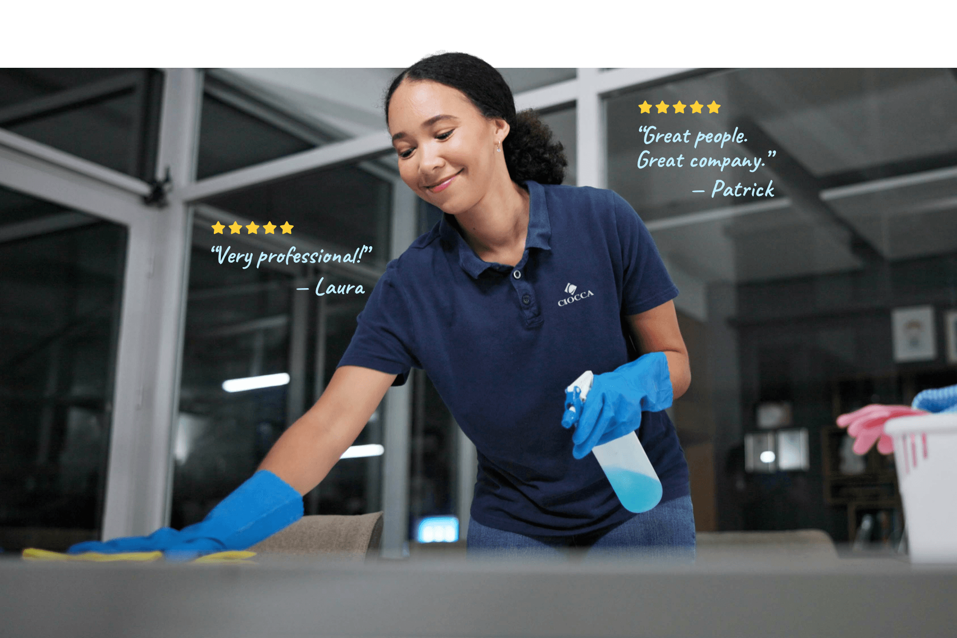 Female employee wearing navy blue shirt cleaning office space by wiping meeting table. Review "Very Professional!" from Laura and review "Great people. Great company." from Patrick.